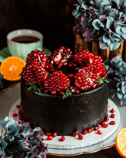 Chocolate cake decorated with peeled pomegranates