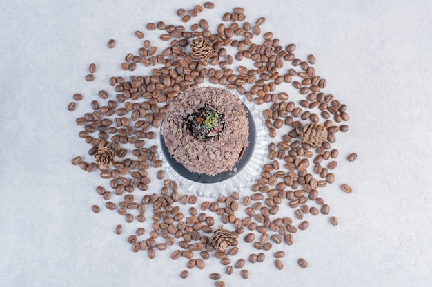 Chocolate cake on glass plate with chocolate chips. 