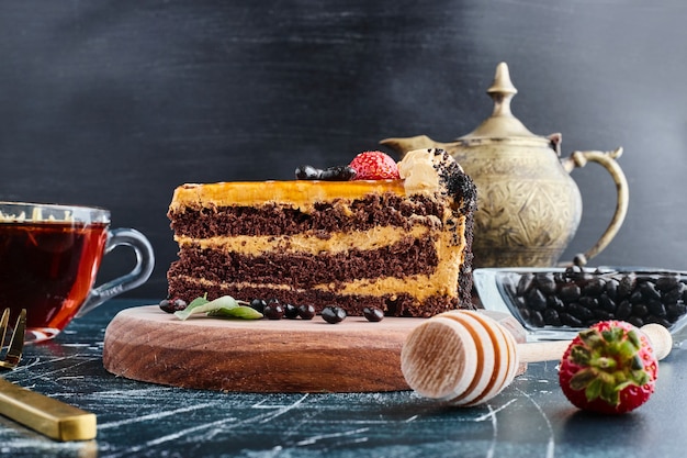 Chocolate cake served with a glass of tea. 