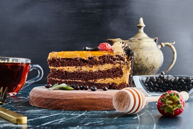 Chocolate cake served with a glass of tea. 