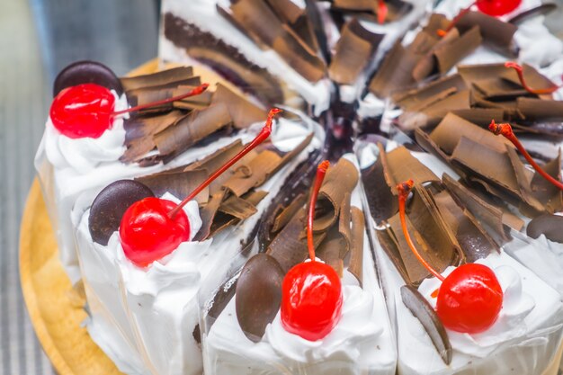 Chocolate cake with red cherries .