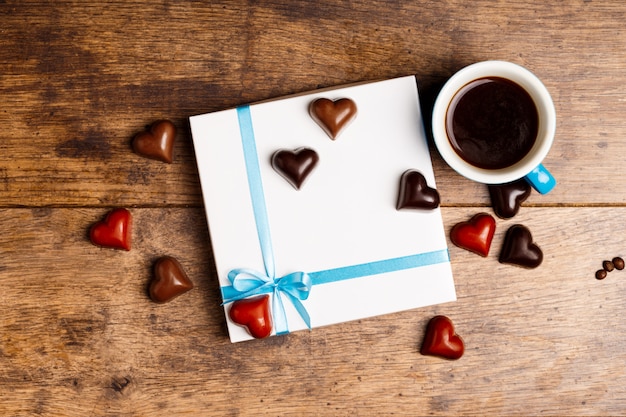 Free photo chocolate candies and coffee on wood