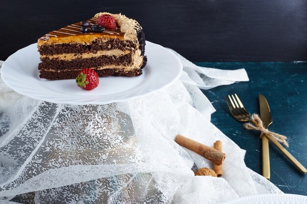 Chocolate caramel cake slices on a white plate. 