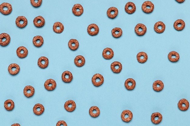 Chocolate cereal loops on pink background