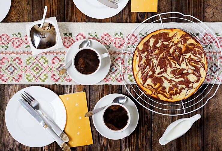 Free Photo chocolate cheesecake and coffee on wooden table. cup coffee and cheesecake.top view. flat lay