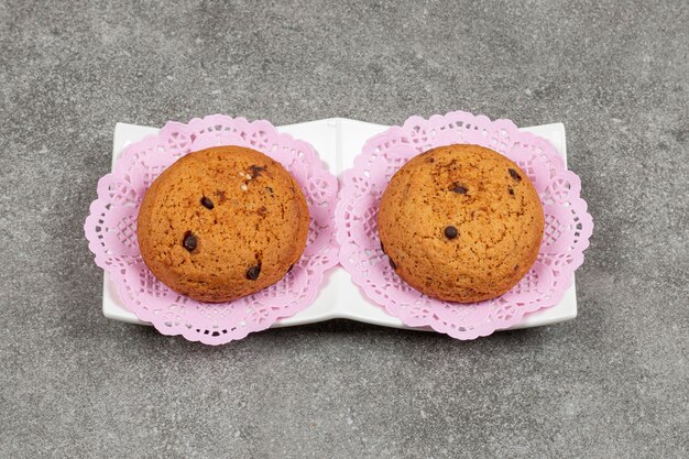 Chocolate chip cookies on white saucer