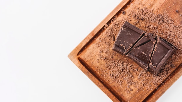 Chocolate between chocolate curls on cutting board