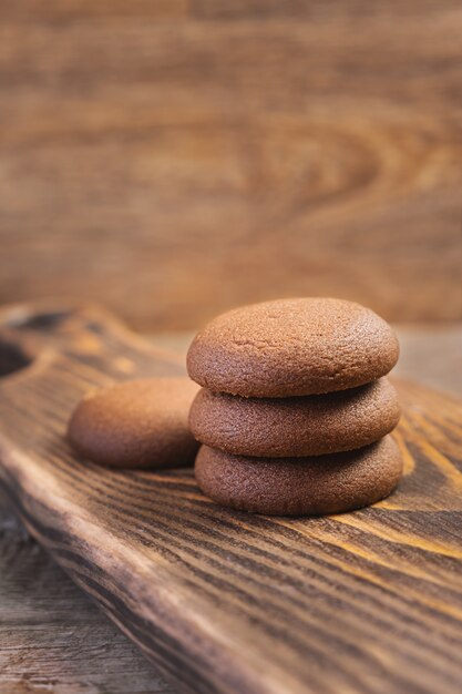 Chocolate cookie on a wooden cutting board