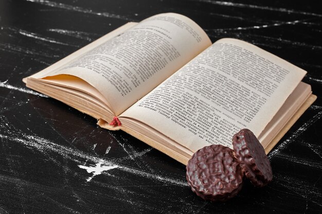 Chocolate cookies with an old book aside. 