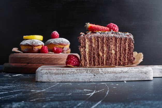 Chocolate crepe cake on a wooden board. 