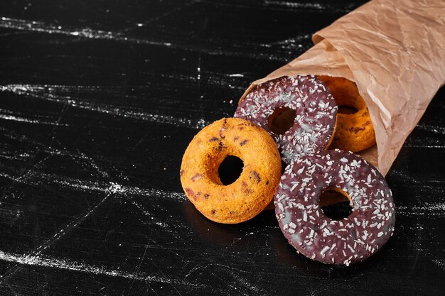 Chocolate doughnuts in a paper wrap.