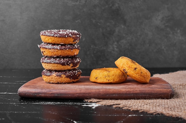 Chocolate doughnuts on a wooden platter