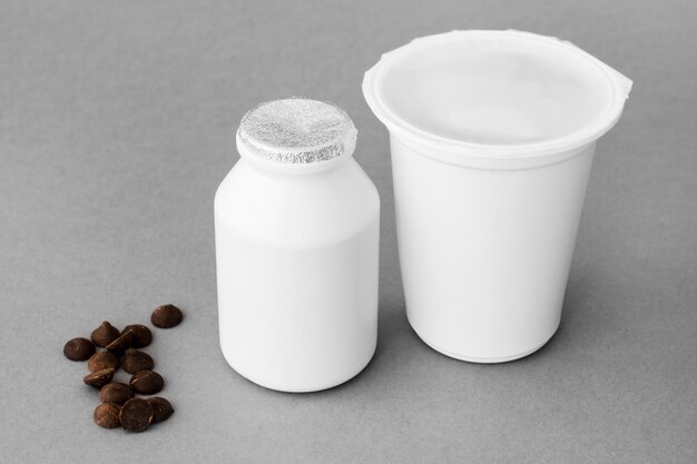 Chocolate drops near containers with dairy