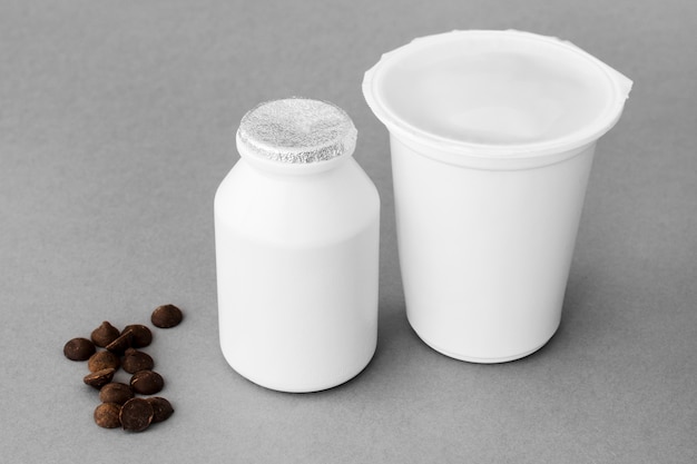 Chocolate drops near containers with dairy