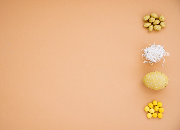 Chocolate Easter eggs with small candies on table