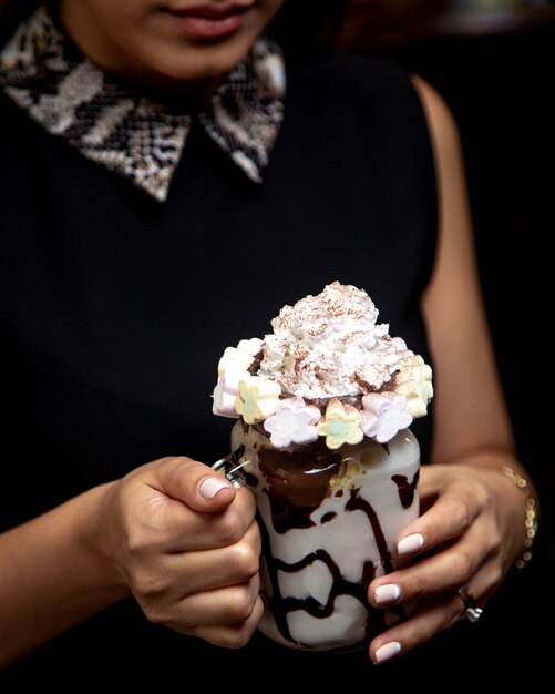 Chocolate frappuccino in woman hands