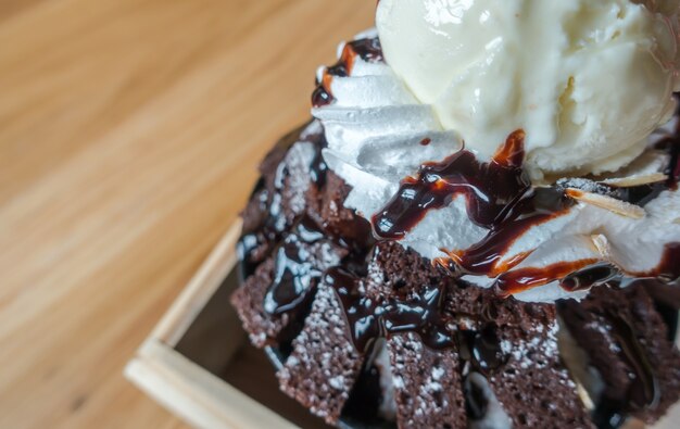 Chocolate ice cream on wood table .