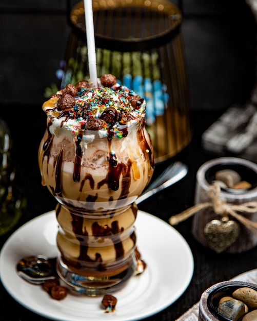 Chocolate latte topped with caramel and candies