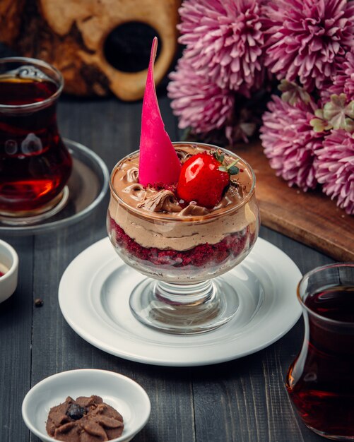 Chocolate mousse with strawberry inside glass.
