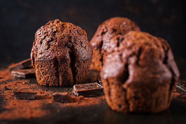 Chocolate muffin on dark surface.