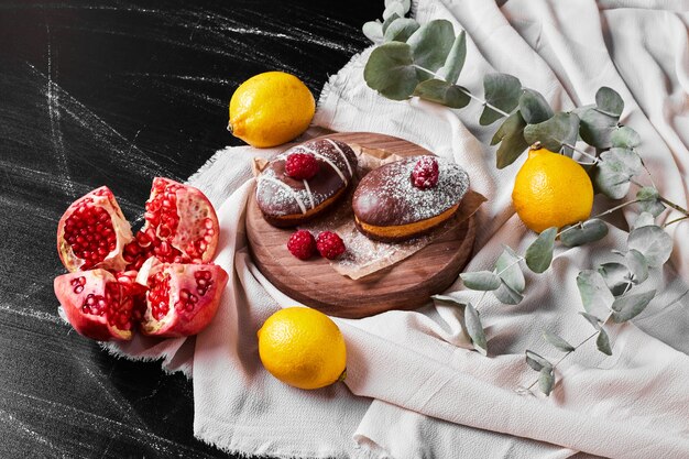 Chocolate muffins on wooden platter .