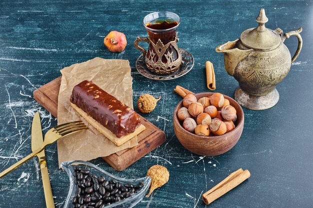 Chocolate nut cake with a glass of tea. 