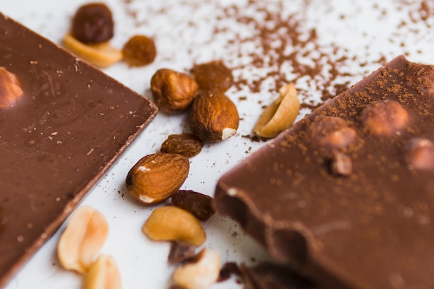 Chocolate and nuts on white background