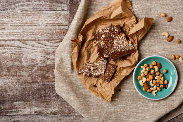 Chocolate and nuts on wood