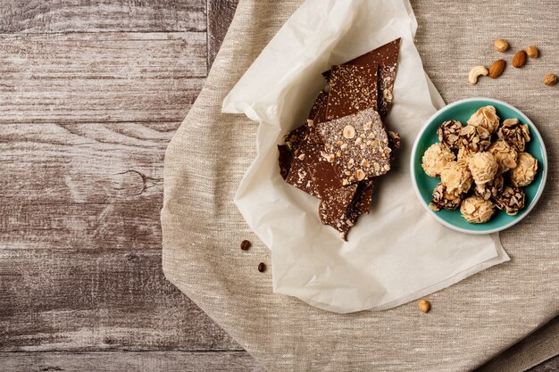 Chocolate and nuts on wood