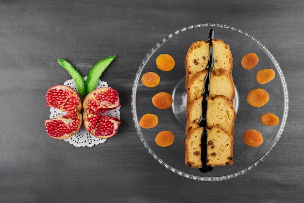 Chocolate pie slices on a glass platter with fruits. 