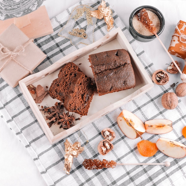 Chocolate pie with gift boxes on table 