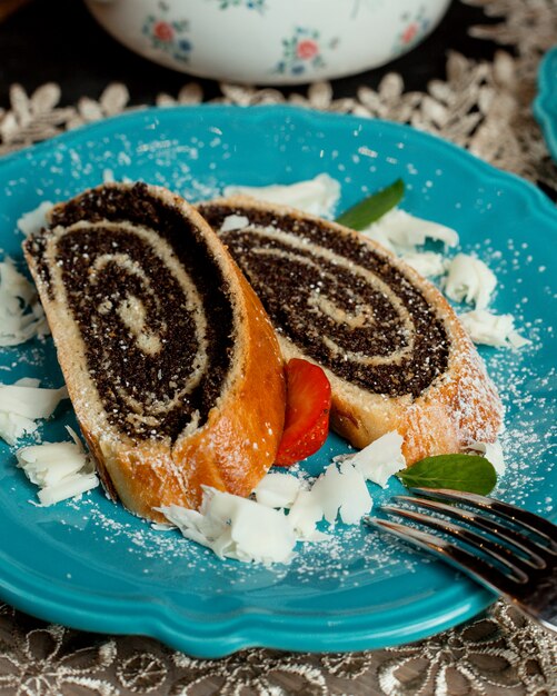 Chocolate roulets on the table under white powder