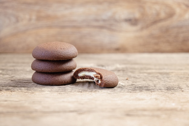 Chocolate round cookies on a wooden background