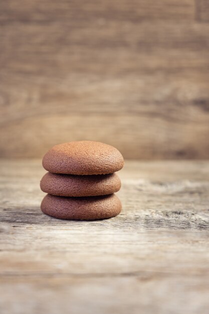 Chocolate round cookies on a wooden background