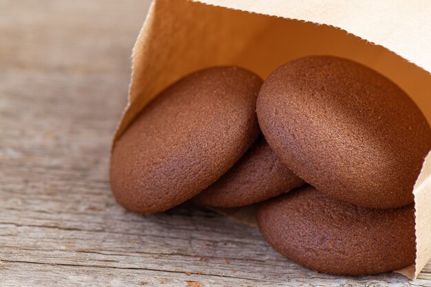 Chocolate round cookies on a wooden background