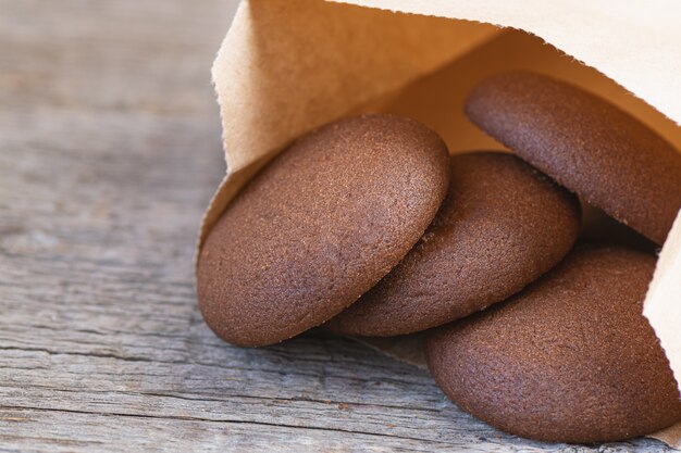 Chocolate round cookies on a wooden background