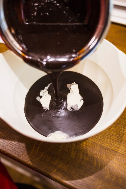 Chocolate sauce flowing into bowl