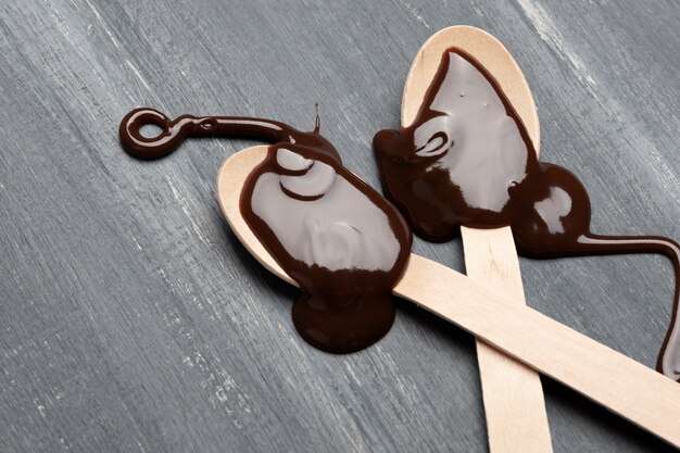 Chocolate sauce on spoon close up