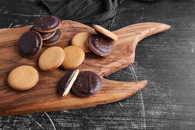 Chocolate sponge cookies on a wooden board. 