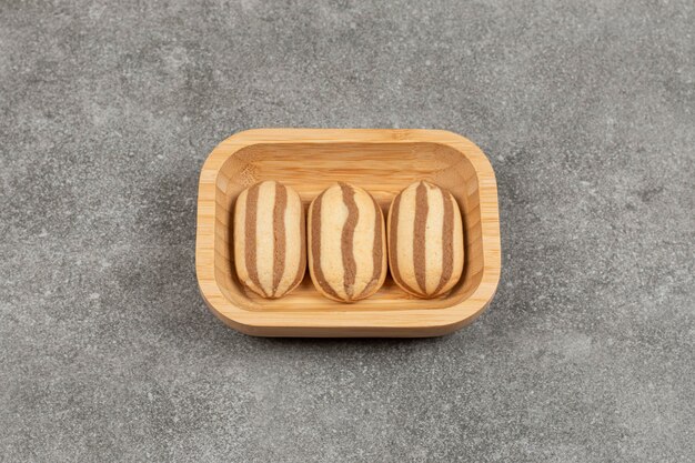 Chocolate striped biscuits on wooden plate