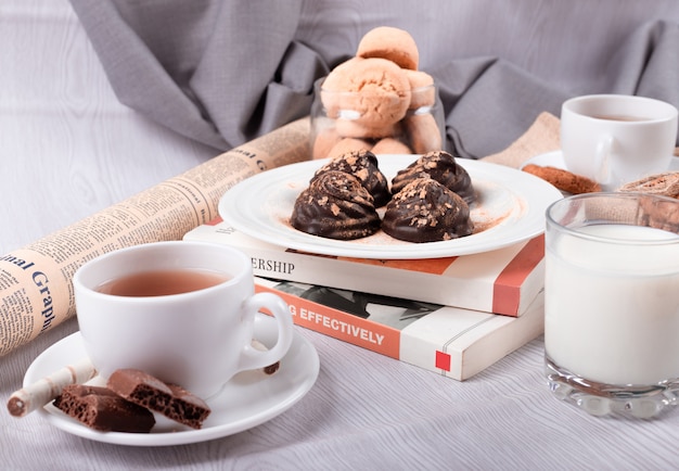 Chocolate, sweet snacks and tea on the table