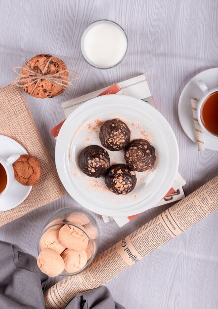 Шоколад, сладкие закуски и чай на столе