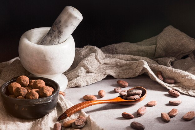 Chocolate truffles in bowl and spoon with cocoa beans