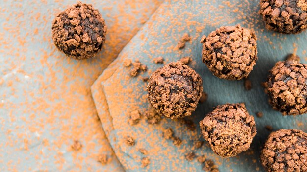 Chocolate truffles with biscuit crumb on stone countertop
