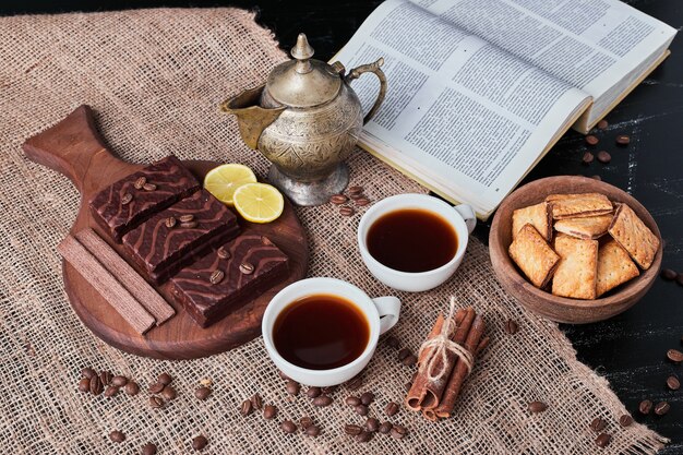 Chocolate waffles with a cup of tea and cookies.