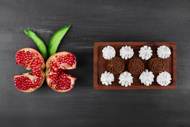 Free photo chocolate waffles with whipping cream and pomegranate.