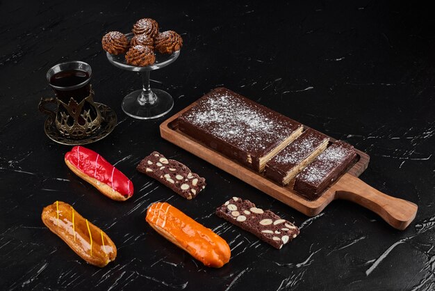 Chocolate waffles on a wooden board with cookies. 