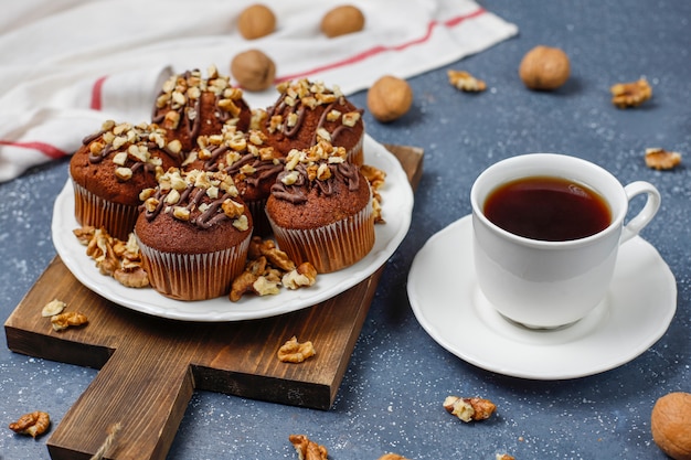 https://img.freepik.com/free-photo/chocolate-walnut-muffins-with-coffee-cup-with-walnuts-on-dark-surface_114579-5333.jpg