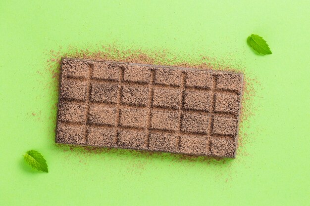 Chocolate with cocoa powder and leaves