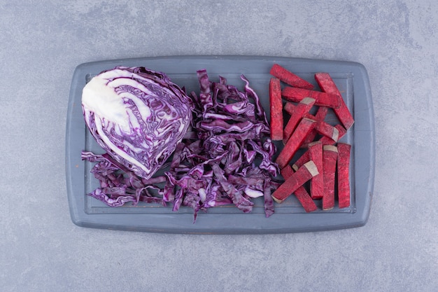 Chopped beetroots with purple cabbage on the board